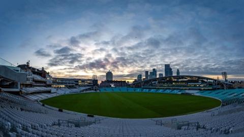 A shot of a cricket ground with the sun setting