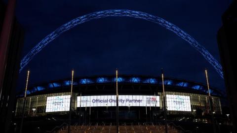 Wembley stadium lit up with the Alzheimer's Society logo