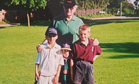 An old photograph of Stan in the garden with his three grandsons