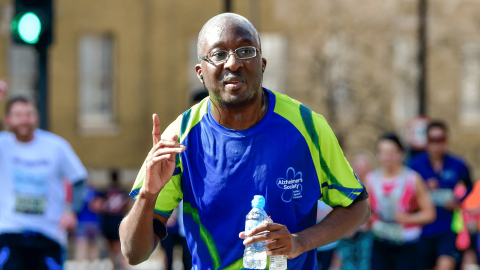 Man running and pointing at London Landmarks Half Marathon