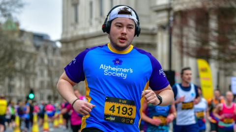 Alzheimer's Society running and wearing cap and headphones