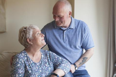 A couple dealing with dementia look lovingly into each other's eyes