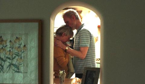 A couple embrace in a doorway