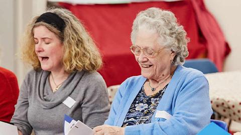 Two women singing, at a Singing for the Brain group.