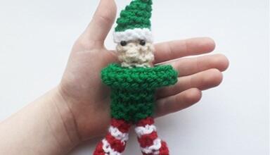 A knitted Snuggle Elf fidget toy in someone's palm