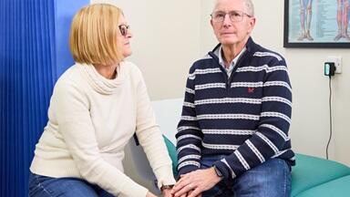 A couple sitting in a doctor's waiting room