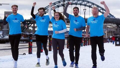Five runners dressed in Alzheimer's Society t-shirts in the snow