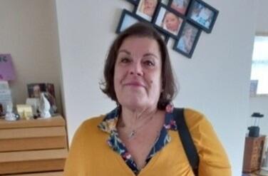 Maria smiling, standing in a lounge space