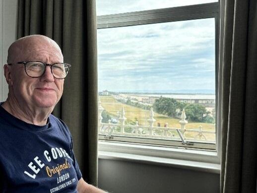Geraint Roberts in front of a lovely window view