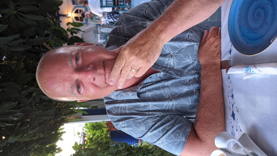 A man wearing a light blue shirt sat at a table