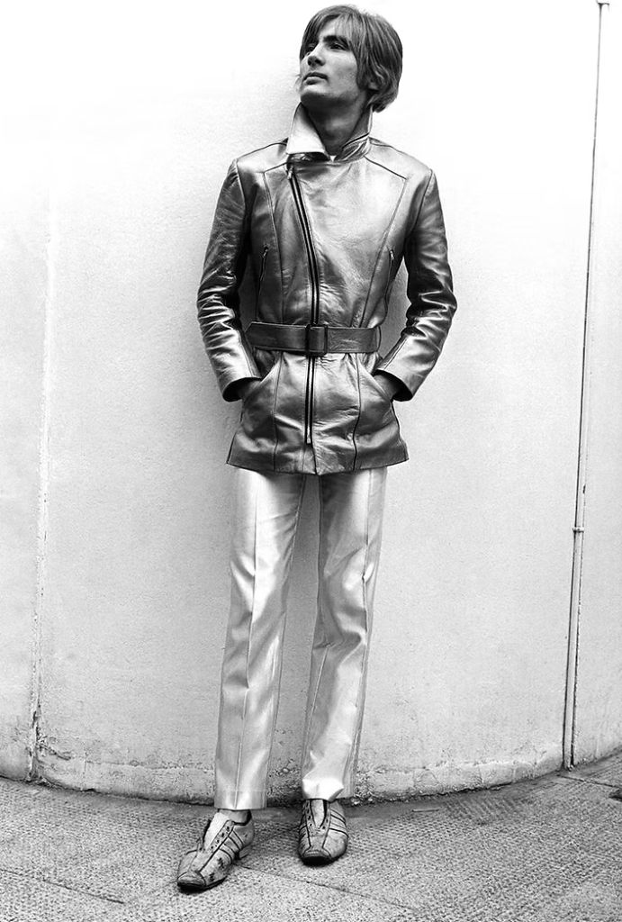 A black and white photo of a man in mid-century clothes