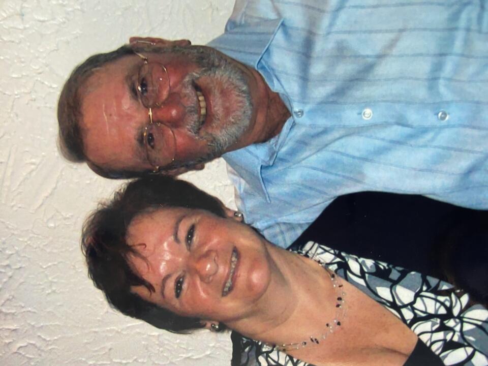 A man and a woman hugging and smiling