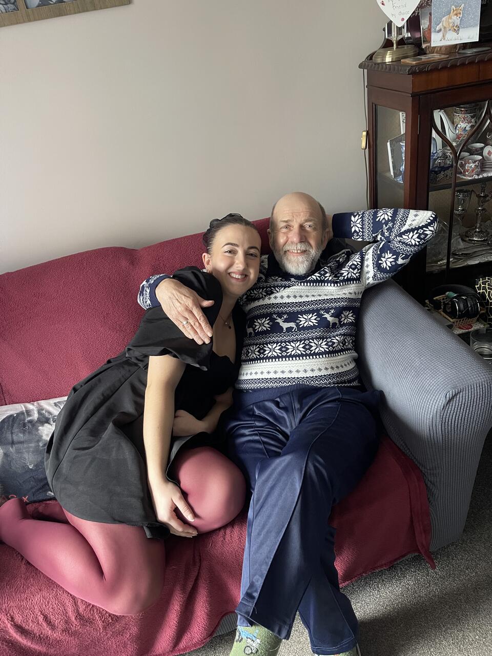 A man hugging a woman on a sofa