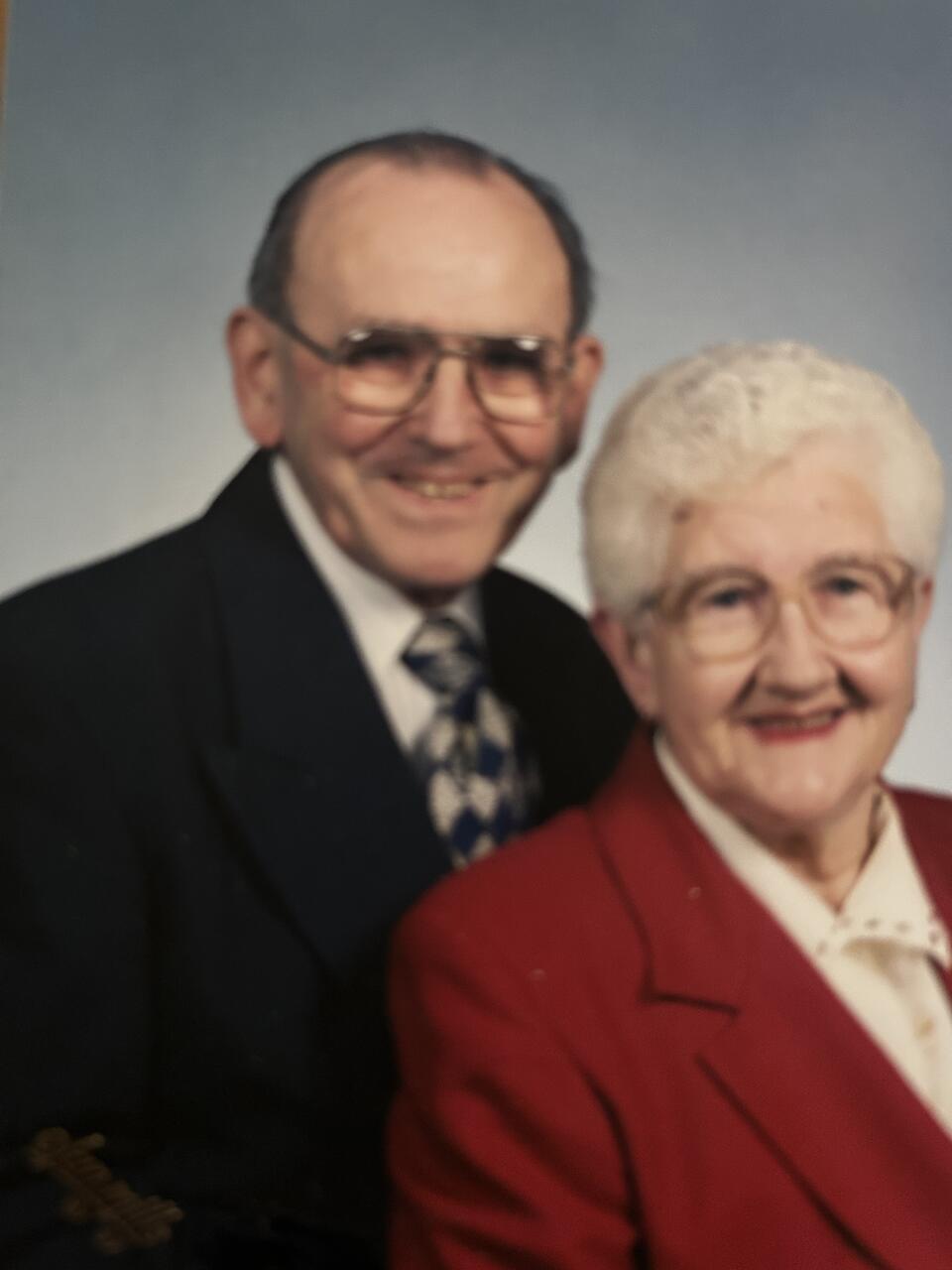 A man stood behind a woman