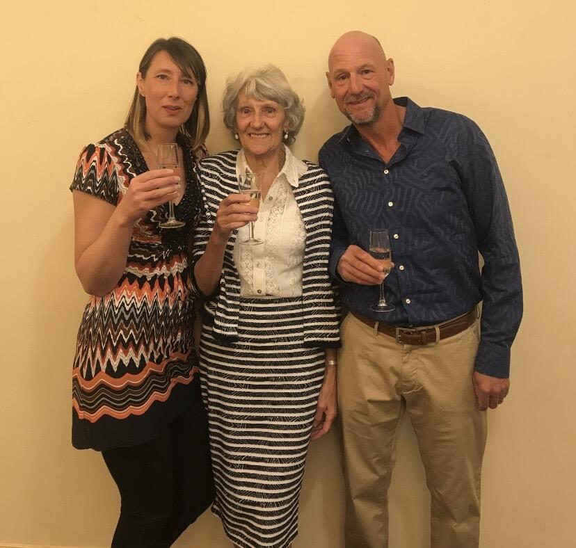 Two woman and a man holding wine glasses