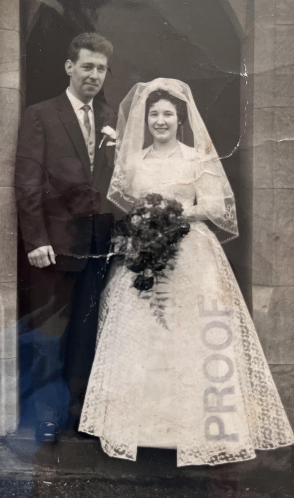 A black and white photo of a groom and bride