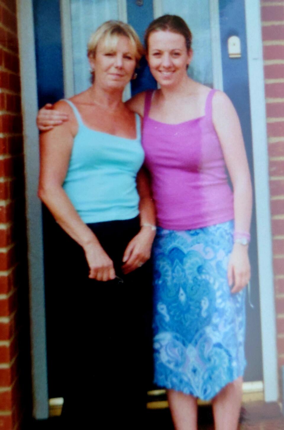A woman with her arm around another woman