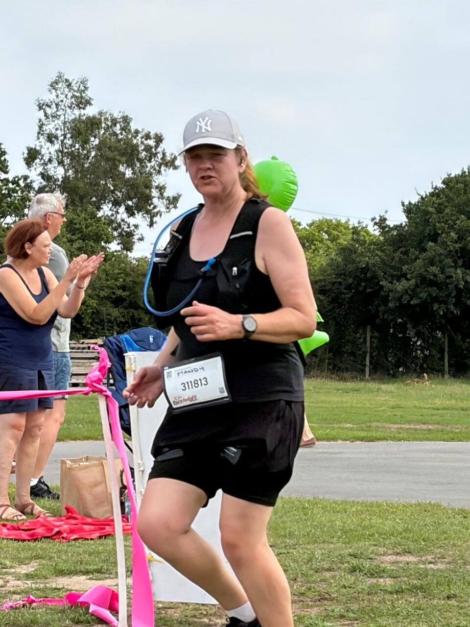 A woman in sports gear running on grass