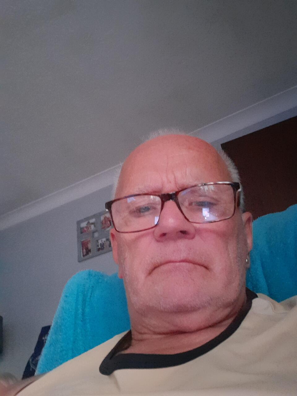 A bald man with glasses