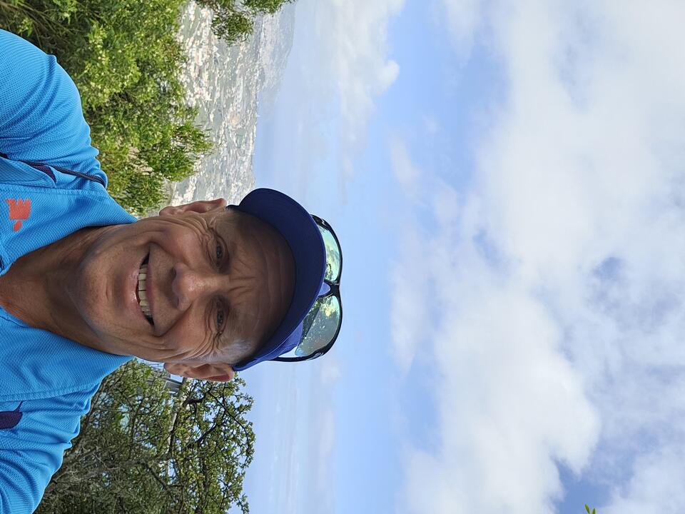 A man wearing a sun hat and a blue t shirt