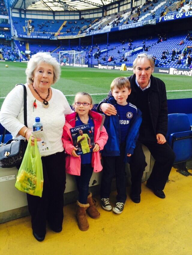 An older man and woman with a girl and boy at a football stadium