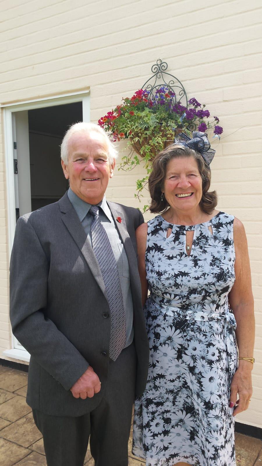 A smiling couple in formalwear