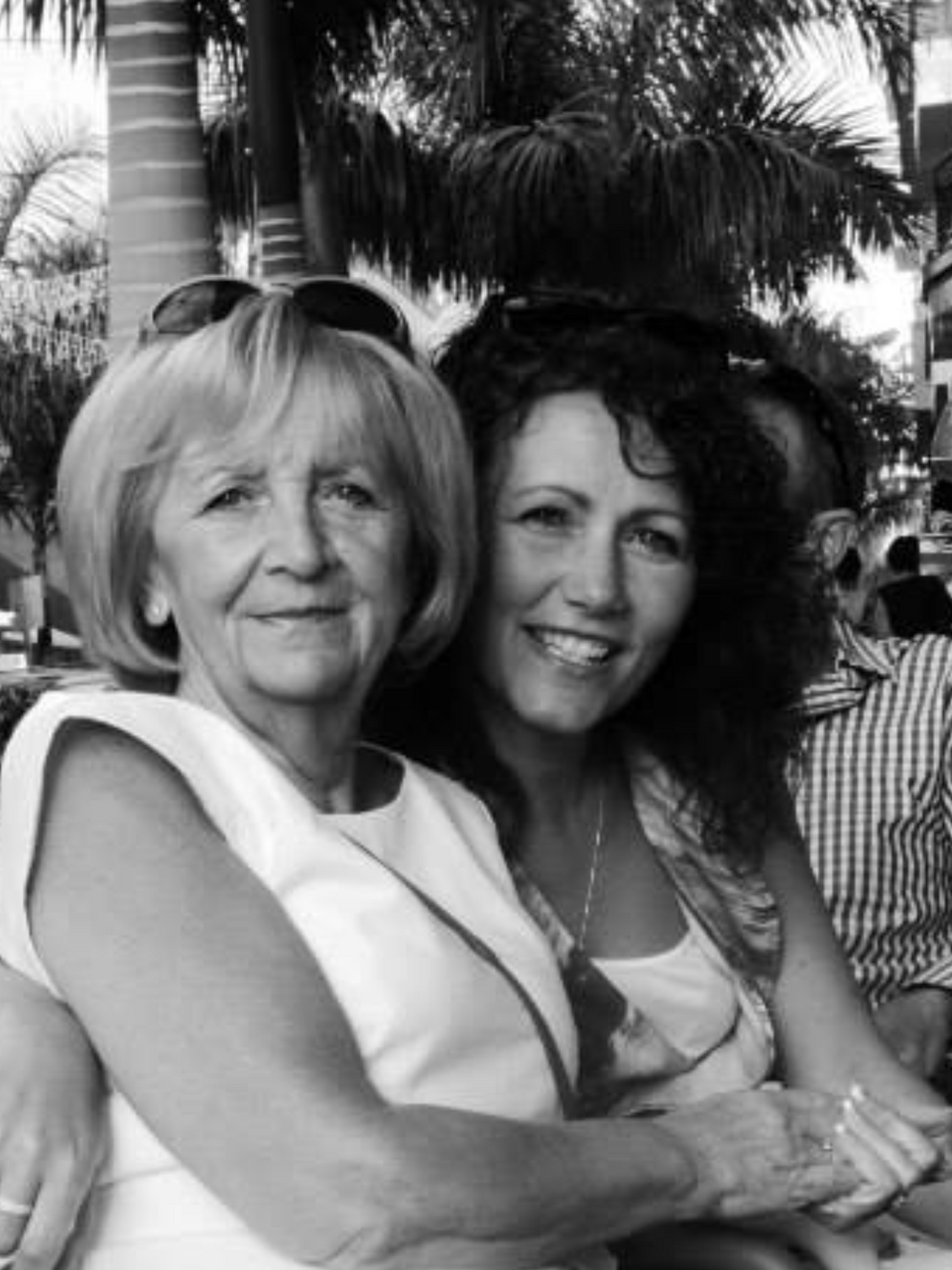 A black and white photo of an older woman sat with a younger woman