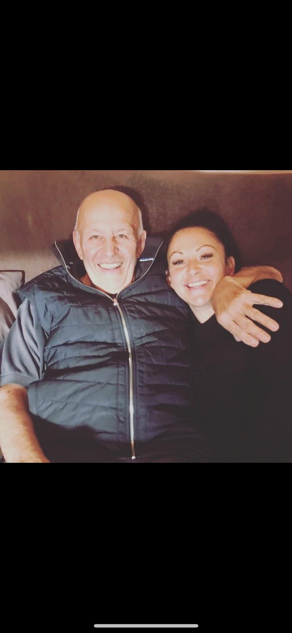 An older man hugging a younger woman