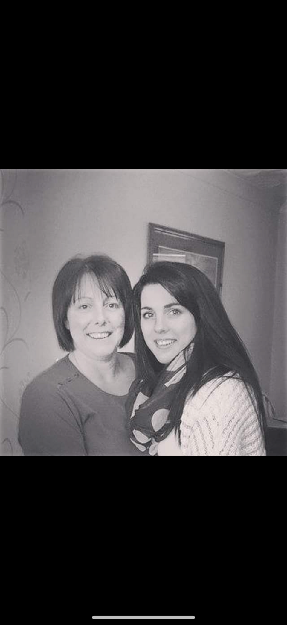 A black and white photo of two woman smiling
