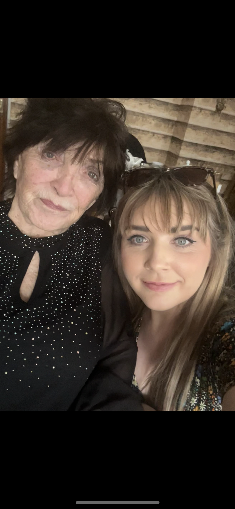 A selfie of a woman with a short brown bob and a younger woman with long blonde hair