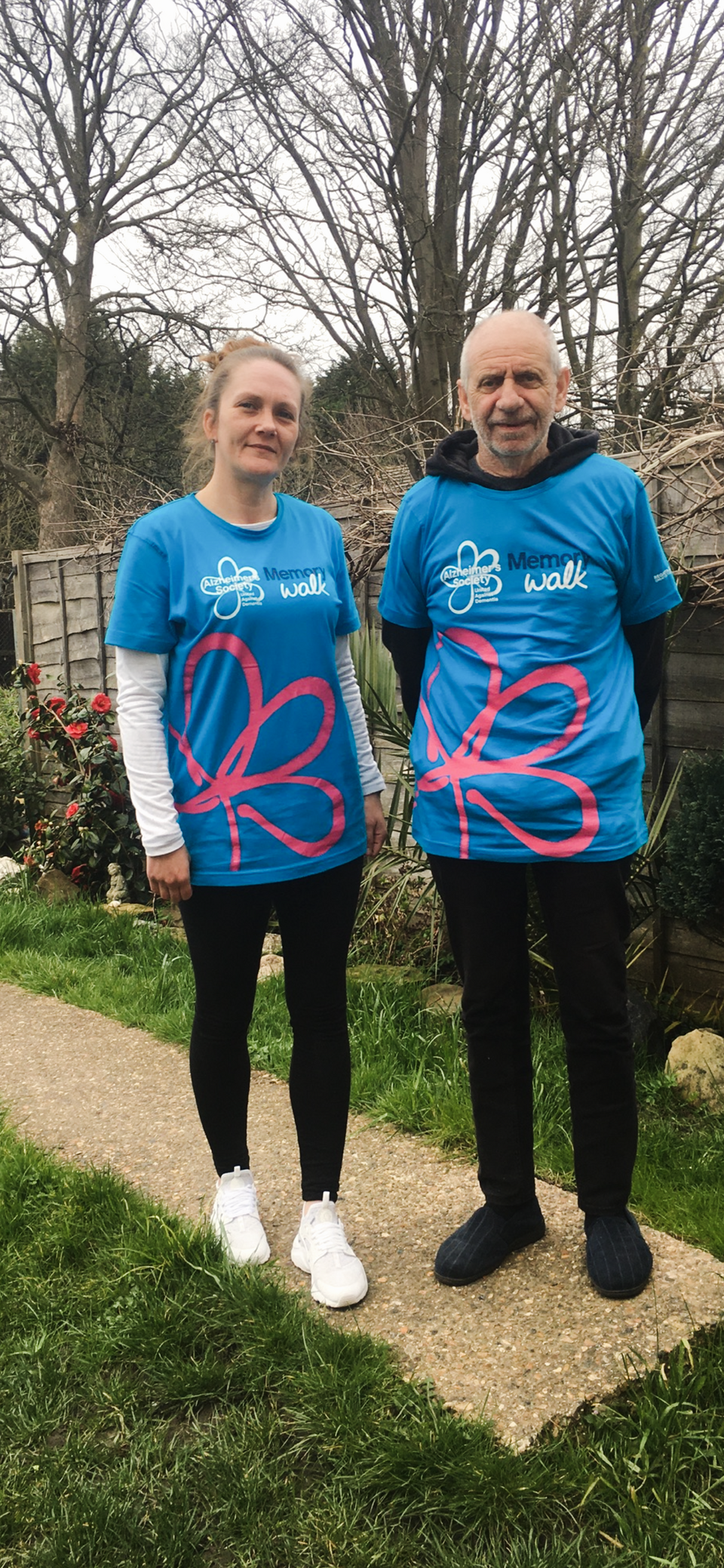 A woman and a man in a garden wearing Memory Walk t-shirts