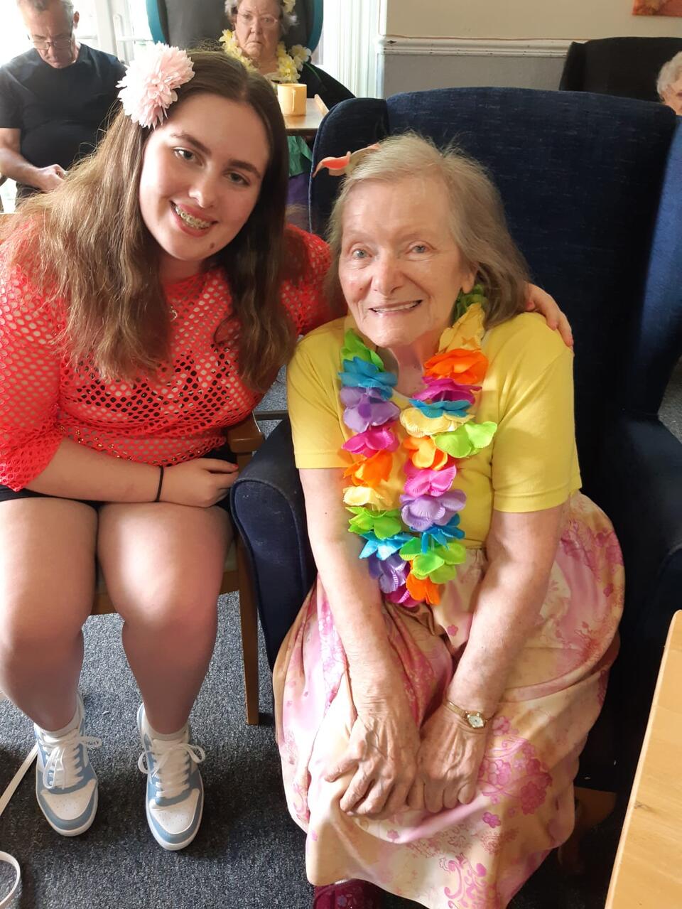 A younger woman and older woman sat on chairs
