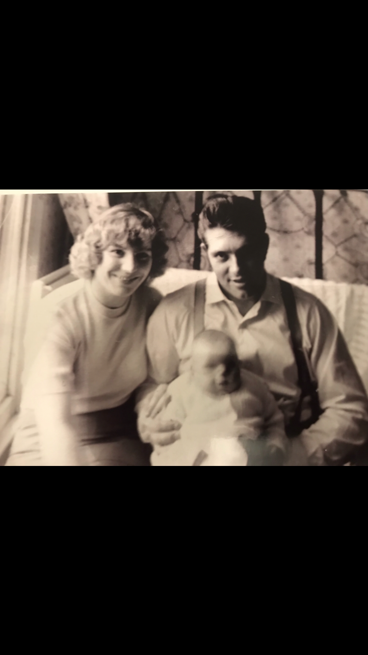 A sepia photo of a man, woman and baby
