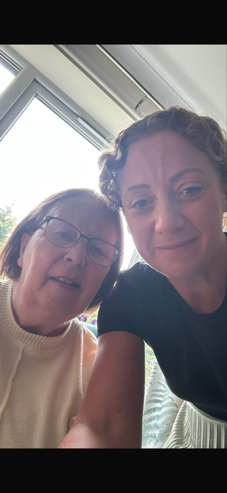 A selfie of a older woman and younger woman