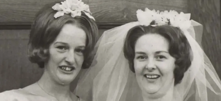 A black and white photo of a bride and her sister