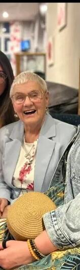 A lady with short grey hair sat down and laughing