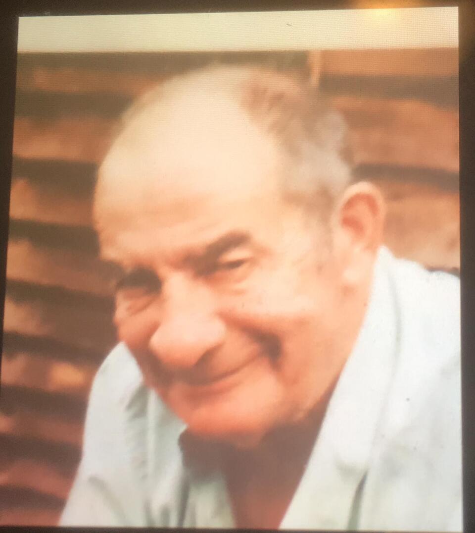 An older man wearing a light blue shirt