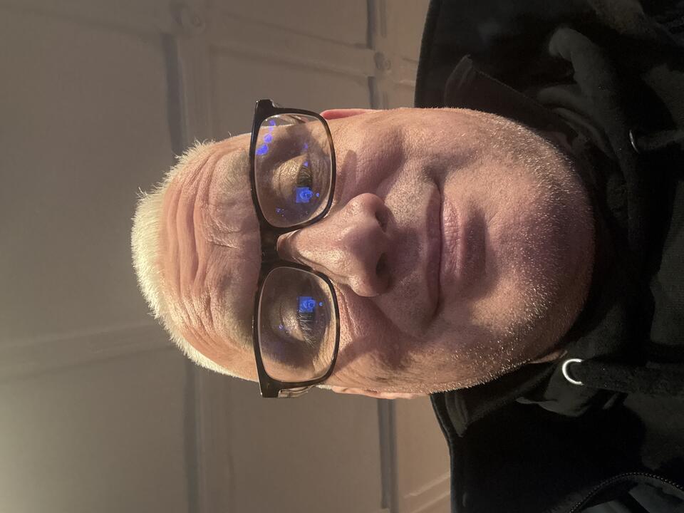 Selfie of a man with glasses and a black top