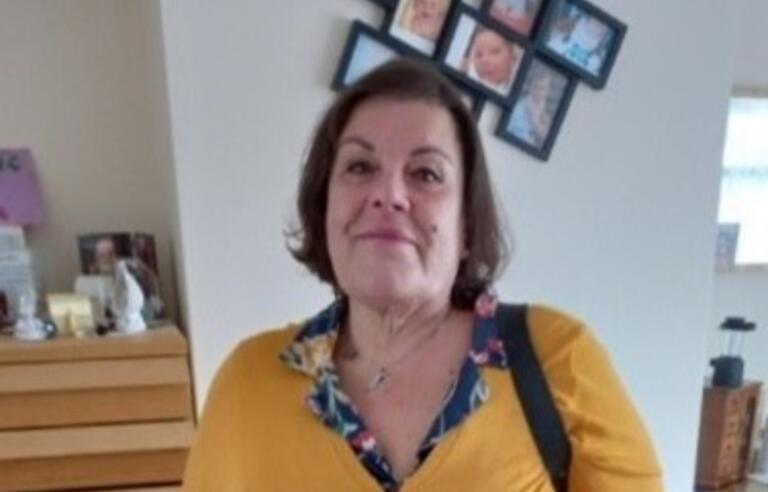 Maria smiling, standing in a lounge space