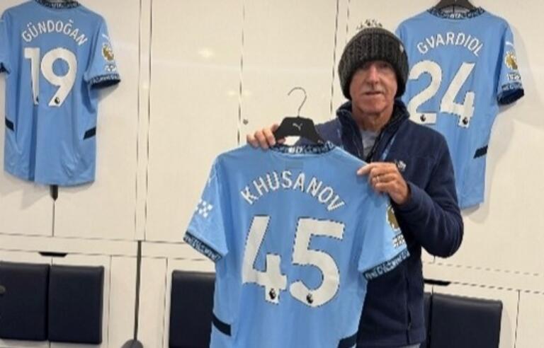 Peter Richardson holding a Manchester City football shirt