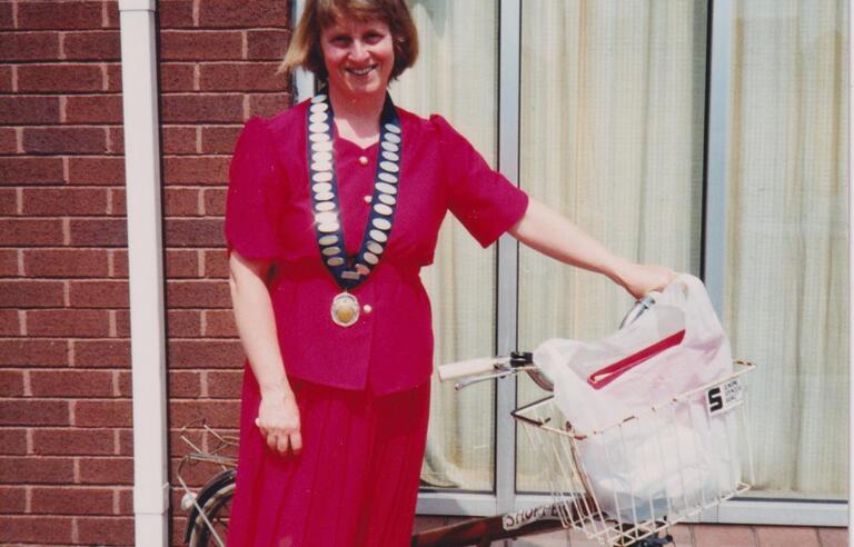 A woman wearing all red next to a bike
