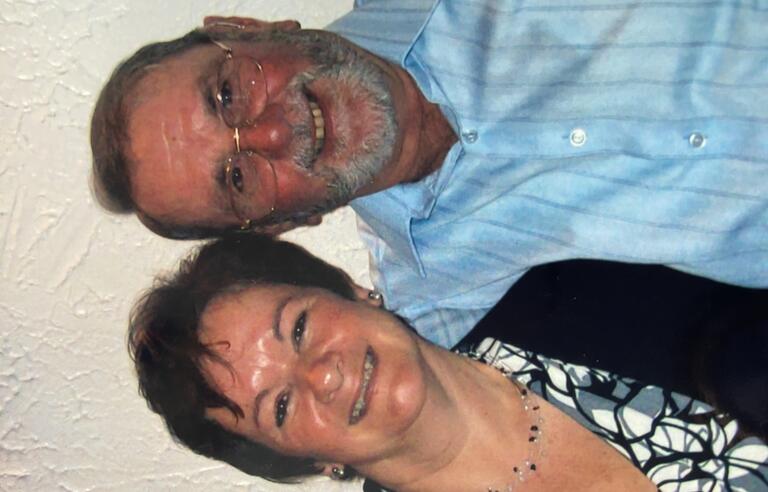 A man and a woman hugging and smiling