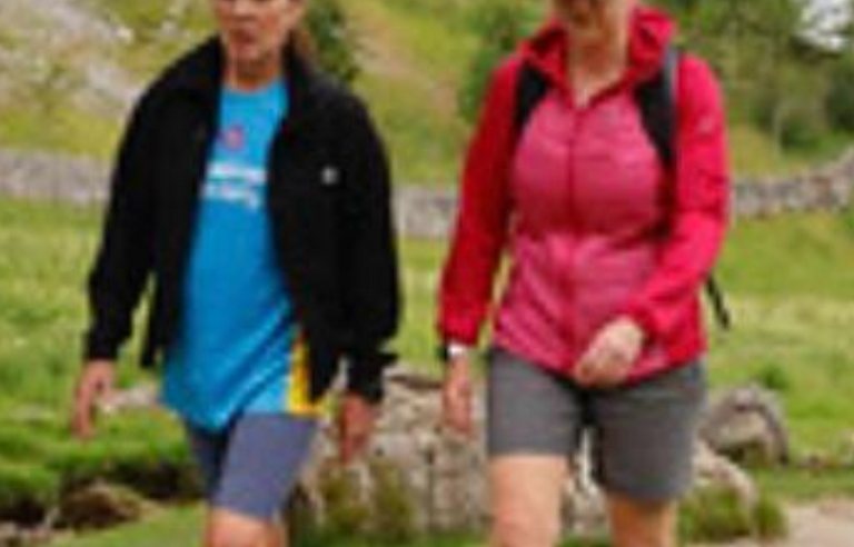 Two people hiking on a path