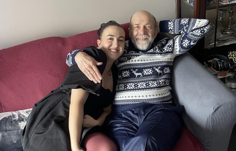 A man hugging a woman on a sofa