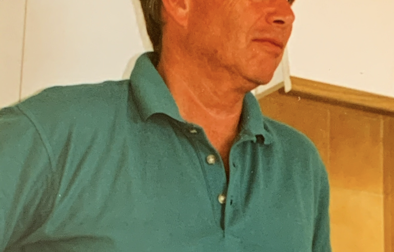 A man wearing a green polo