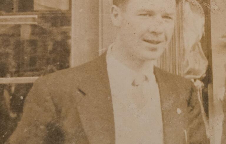 A sepia photo of a man in a suit