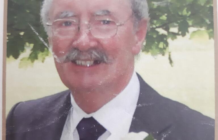 A smiling man in a suit