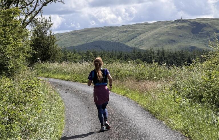 A woman running on a countryside road