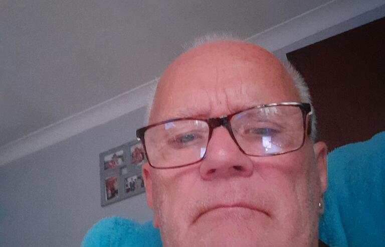 A bald man with glasses