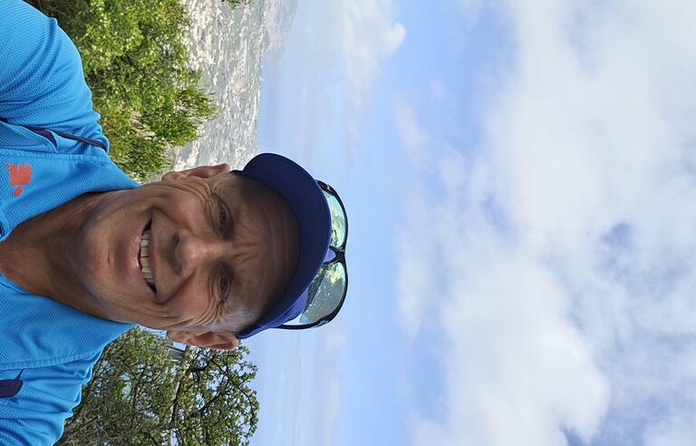 A man wearing a sun hat and a blue t shirt